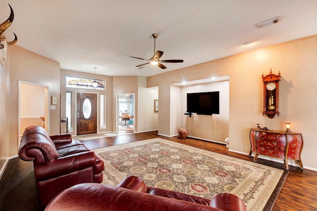 living room featuring dark hardwood / wood-style floors and ceiling fan