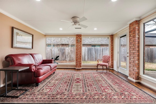 interior space featuring hardwood / wood-style flooring, ornamental molding, and ceiling fan