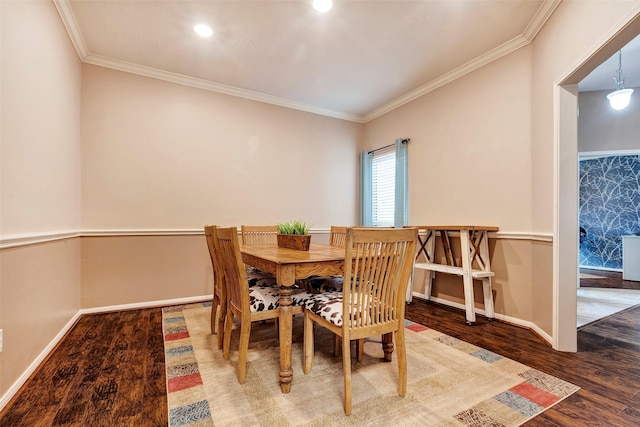 dining area with ornamental molding and wood-type flooring