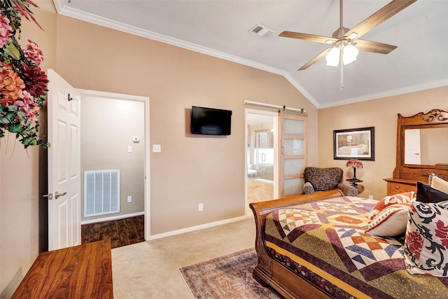 carpeted bedroom featuring vaulted ceiling, ensuite bathroom, ornamental molding, ceiling fan, and a barn door