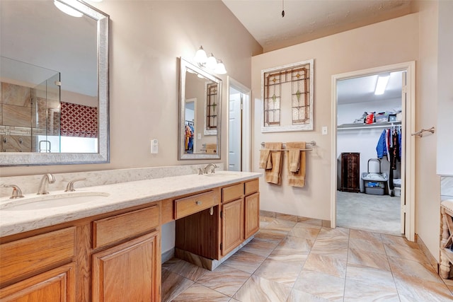 bathroom with a shower with door and vanity