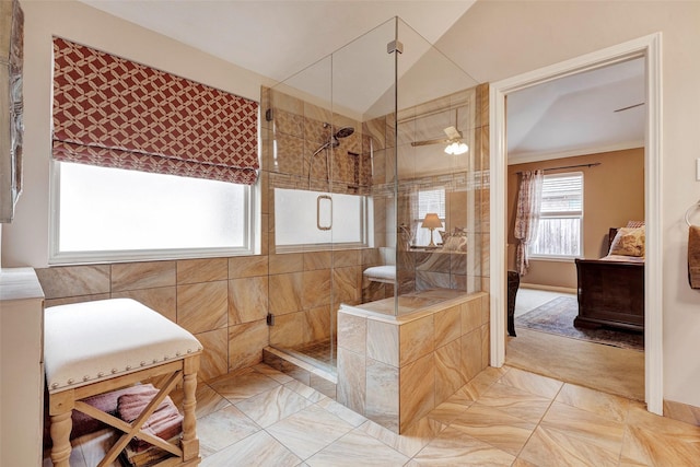 bathroom featuring lofted ceiling, tiled shower, tile patterned floors, and ceiling fan