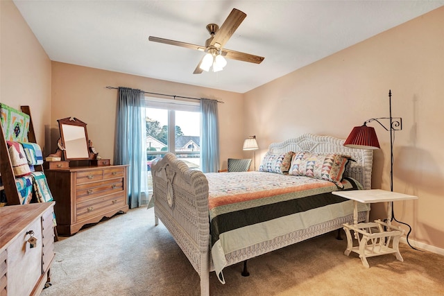 bedroom featuring light colored carpet and ceiling fan