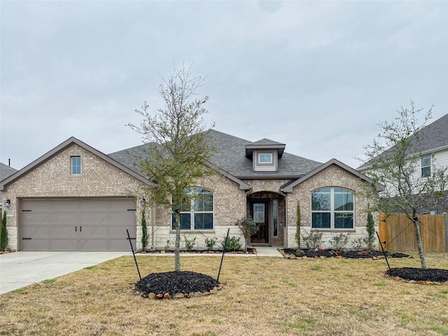 view of front of house featuring a garage and a front lawn