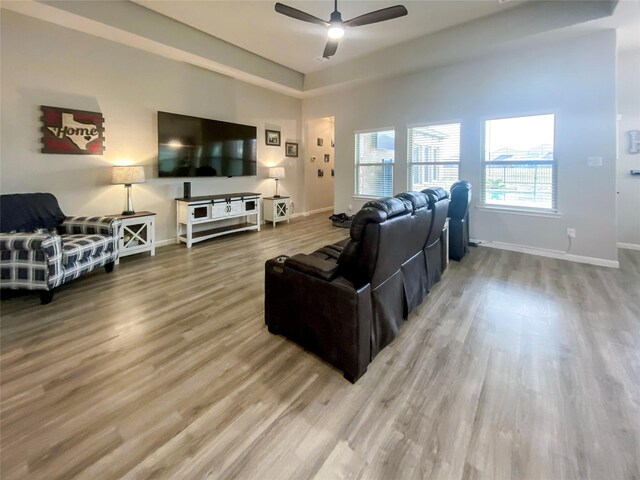 living room featuring hardwood / wood-style floors and ceiling fan