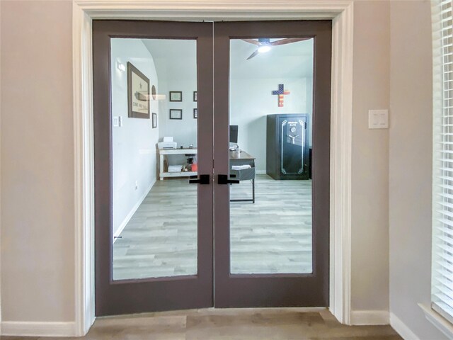 entryway with french doors, light wood-type flooring, and baseboards