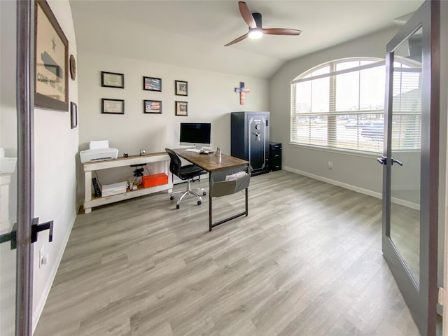 office with baseboards, lofted ceiling, ceiling fan, and light wood finished floors