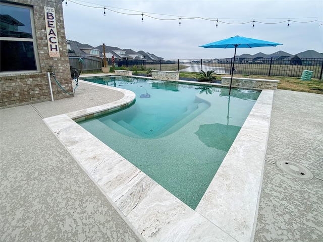 view of pool with pool water feature and a patio