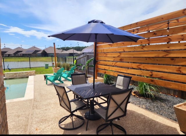 view of patio with outdoor dining space and a fenced backyard