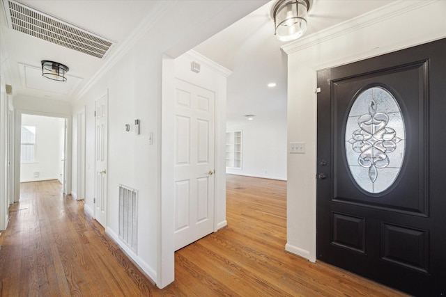 entrance foyer featuring hardwood / wood-style floors and ornamental molding