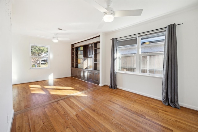 spare room featuring wood-type flooring and ceiling fan