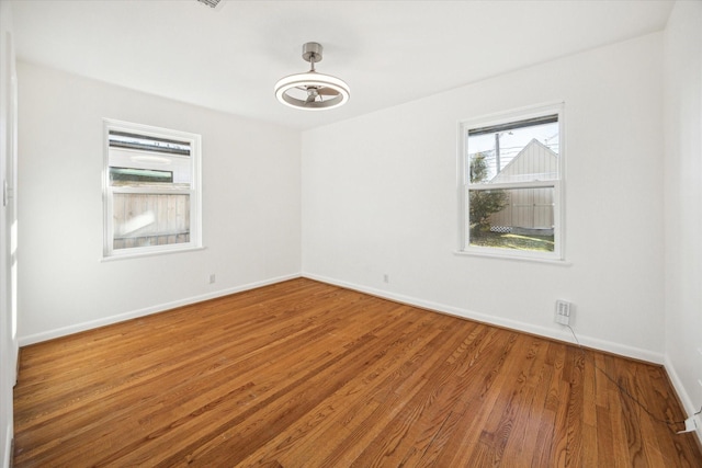 unfurnished room with hardwood / wood-style floors