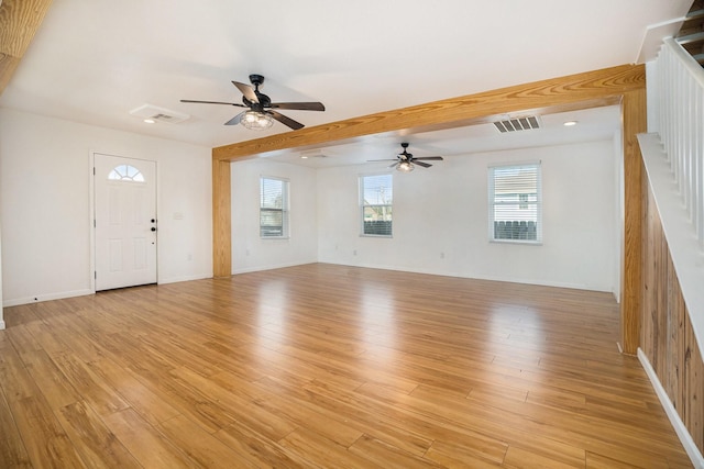 unfurnished living room with ceiling fan and light wood-type flooring