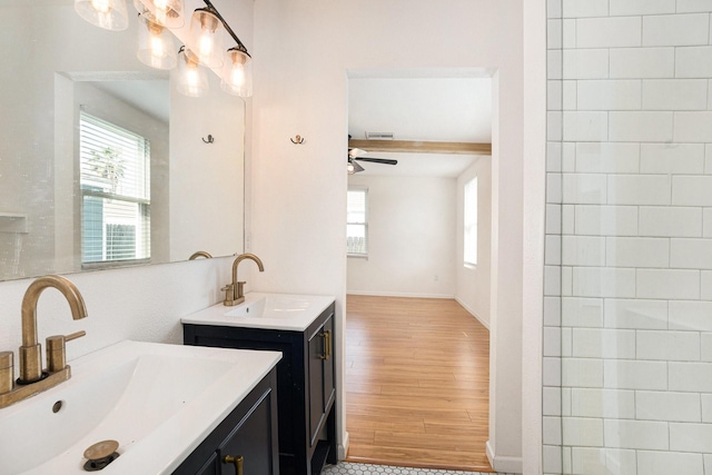 bathroom featuring vanity, hardwood / wood-style flooring, beam ceiling, and ceiling fan