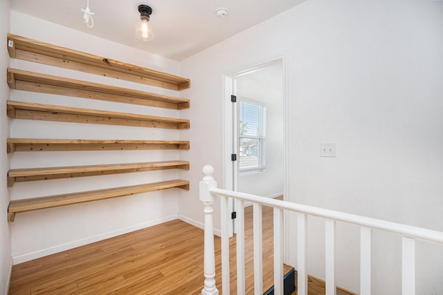 stairway with hardwood / wood-style floors