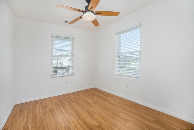 spare room featuring ceiling fan and light hardwood / wood-style flooring