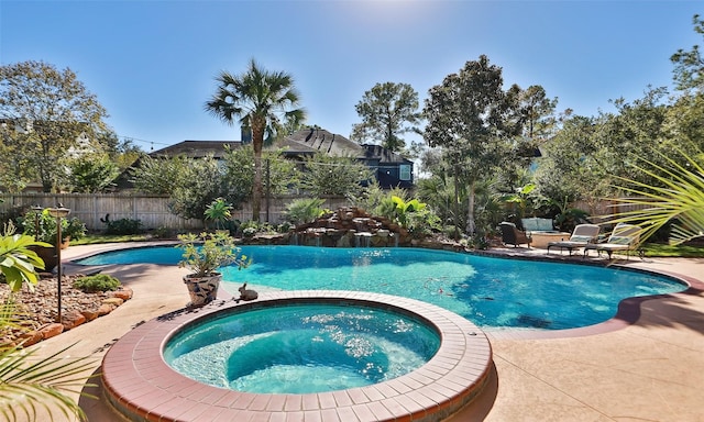 view of swimming pool with an in ground hot tub and a patio