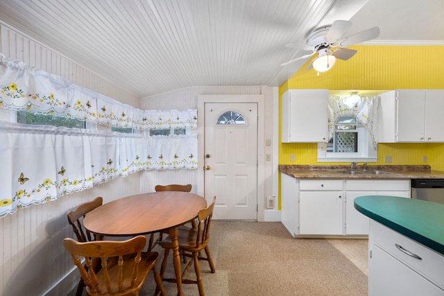 kitchen featuring sink, dishwasher, ceiling fan, white cabinets, and light colored carpet