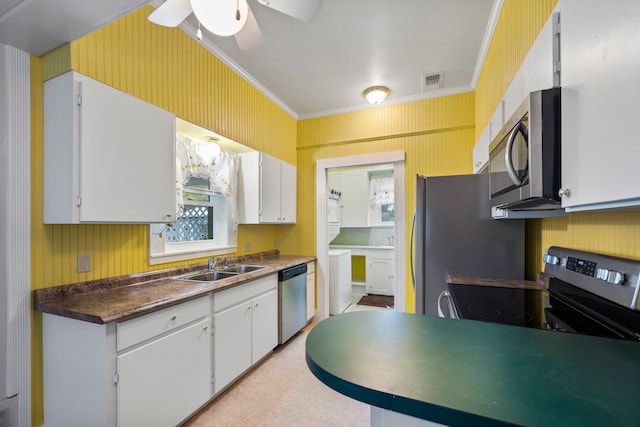 kitchen featuring white cabinetry, stainless steel appliances, crown molding, and sink