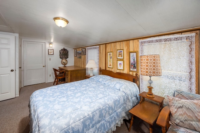 bedroom featuring carpet floors and wooden walls