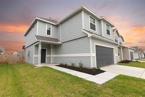 front facade with a garage and a yard