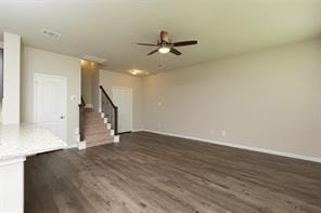 unfurnished living room featuring ceiling fan and dark hardwood / wood-style floors