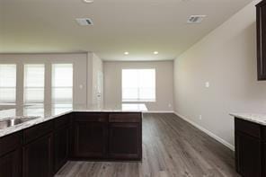 kitchen with hardwood / wood-style flooring and dark brown cabinetry