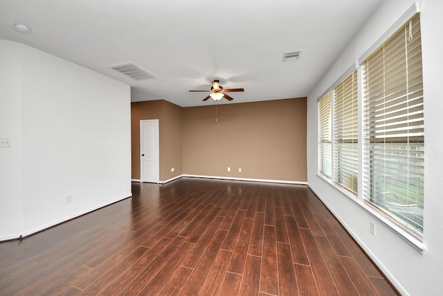 spare room with ceiling fan and dark hardwood / wood-style flooring