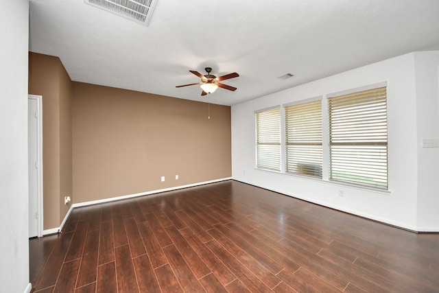 empty room featuring dark hardwood / wood-style floors and ceiling fan