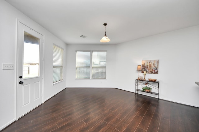 unfurnished room featuring dark wood-type flooring