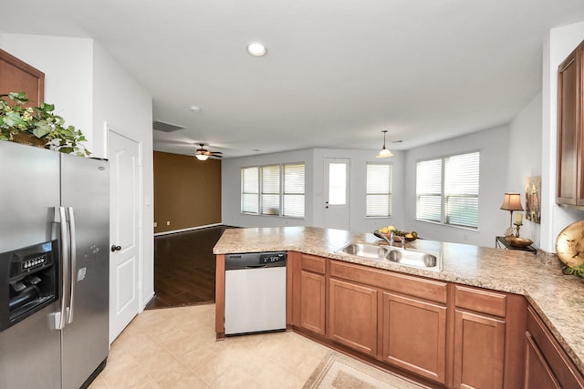 kitchen with sink, appliances with stainless steel finishes, kitchen peninsula, pendant lighting, and ceiling fan