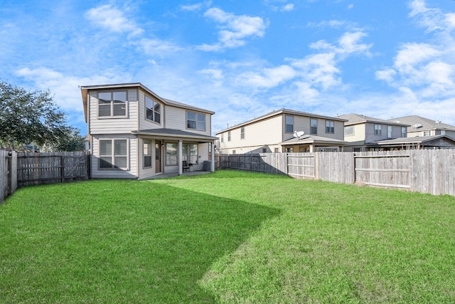 rear view of house featuring a patio, a yard, and central AC