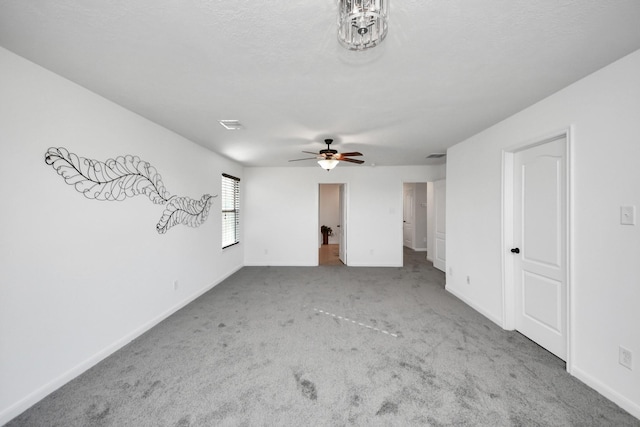 interior space featuring ceiling fan, carpet flooring, and a textured ceiling