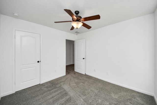 unfurnished bedroom featuring ceiling fan and dark carpet