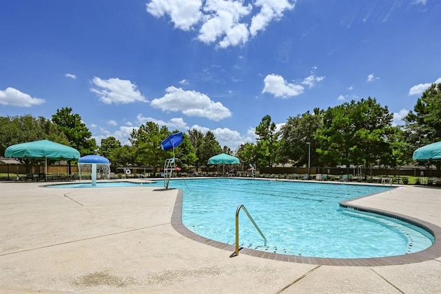 view of swimming pool with a patio and pool water feature