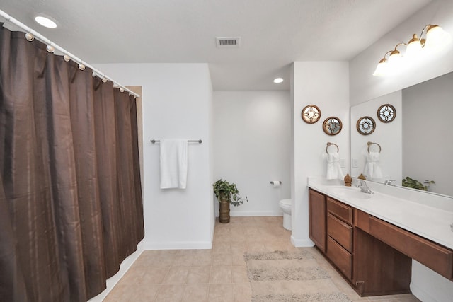 bathroom with tile patterned floors, vanity, and toilet