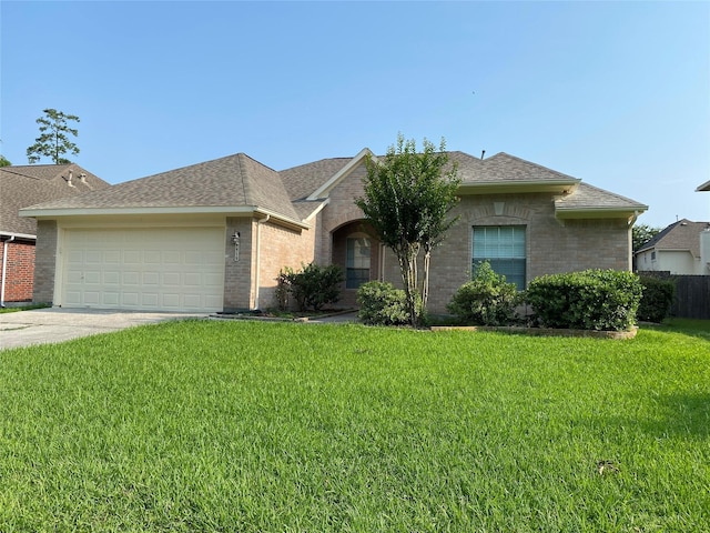 ranch-style house with a garage and a front lawn