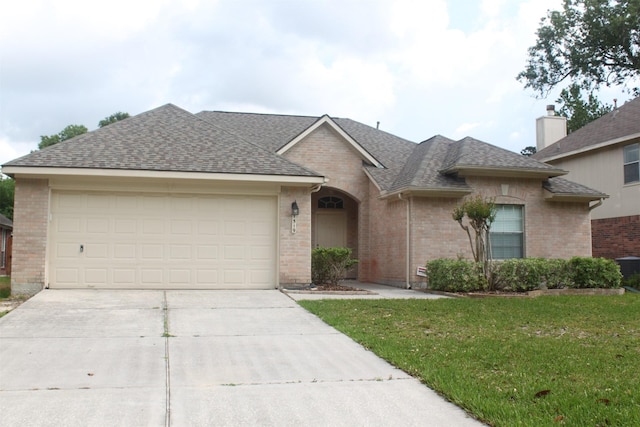 ranch-style home featuring a garage and a front yard