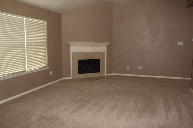 unfurnished living room featuring a fireplace and carpet