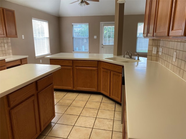 kitchen with lofted ceiling, sink, light tile patterned floors, ceiling fan, and tasteful backsplash