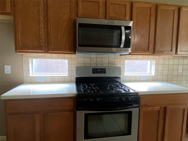 kitchen featuring stainless steel appliances and decorative backsplash