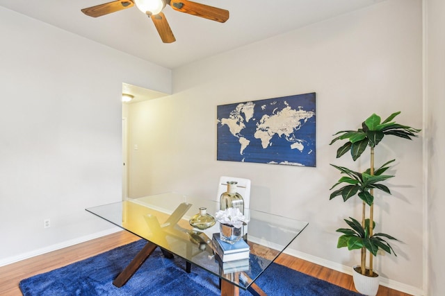 office space with ceiling fan, baseboards, and wood finished floors