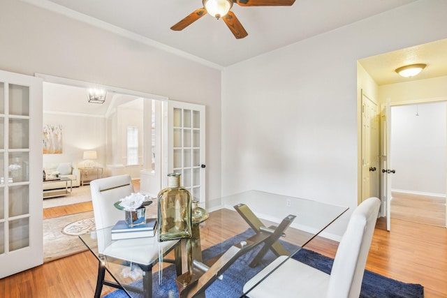 dining space featuring hardwood / wood-style flooring, french doors, and ceiling fan