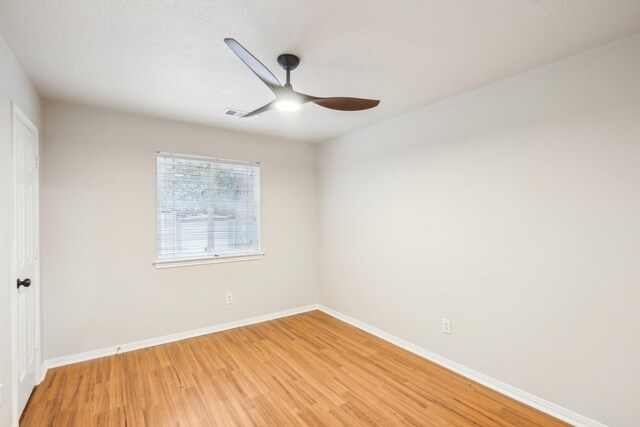 spare room featuring wood-type flooring and ceiling fan