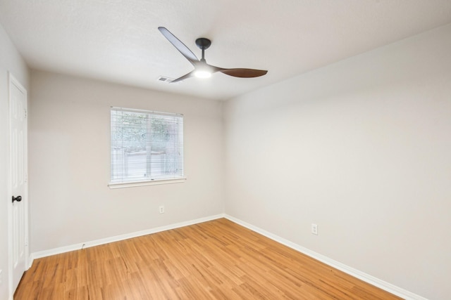 unfurnished room with light wood-style flooring, a ceiling fan, and baseboards