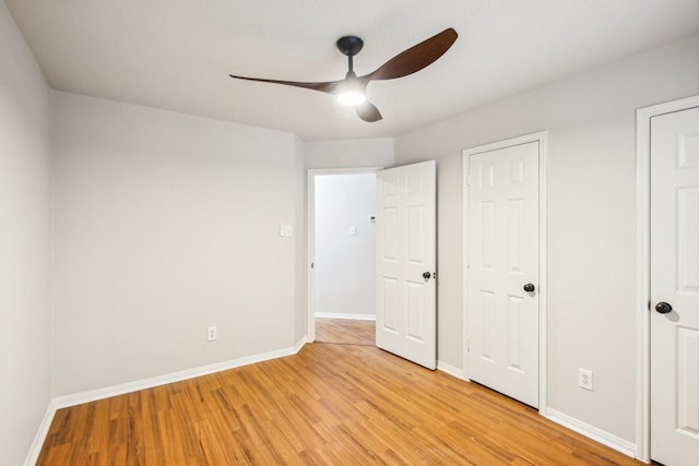 unfurnished bedroom featuring ceiling fan and light wood-type flooring