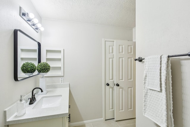 bathroom with vanity, ornamental molding, tile patterned floors, and a textured ceiling