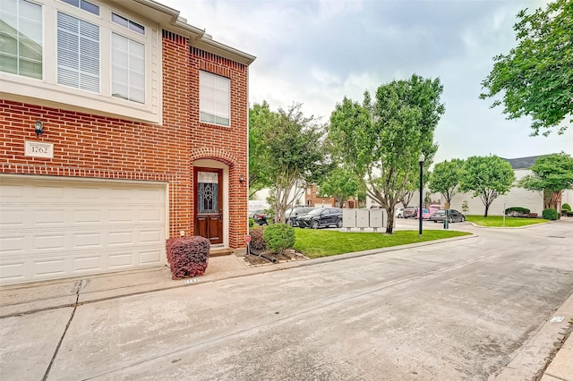 view of front of house with a garage and a front yard