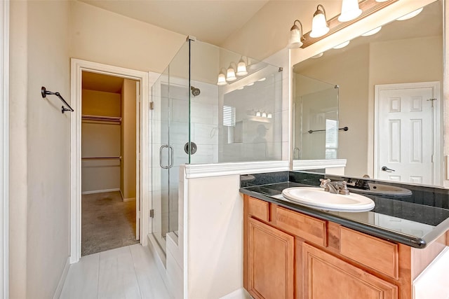 bathroom with vanity, tile patterned flooring, and walk in shower