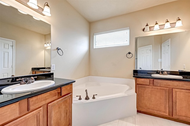 bathroom featuring vanity, a tub, and tile patterned floors